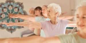 Group of senior women doing a yoga class