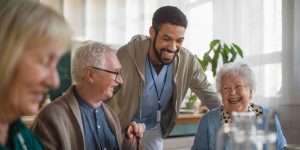 Seniors laughing and chatting in assisted living facility