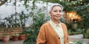 Older woman smiling in garden setting